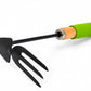 A small black metal hand garden tool with a pointed blade and three tines, featuring a cork-textured handle section and a bright green wrapped grip, shown on a plain white background.