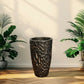 Decorative textured plant pot on a wooden floor with plants on either  black-gold-stone-fiberglass-pot-plantmartpkside.